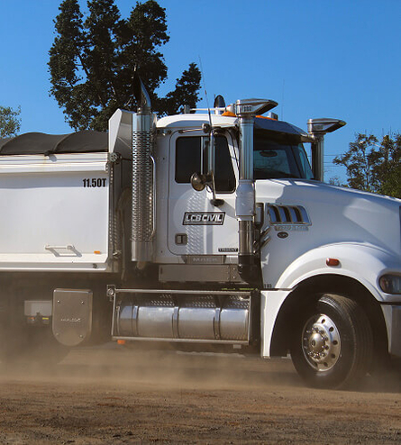 Large truck taking hard rock from quarry to delivery site